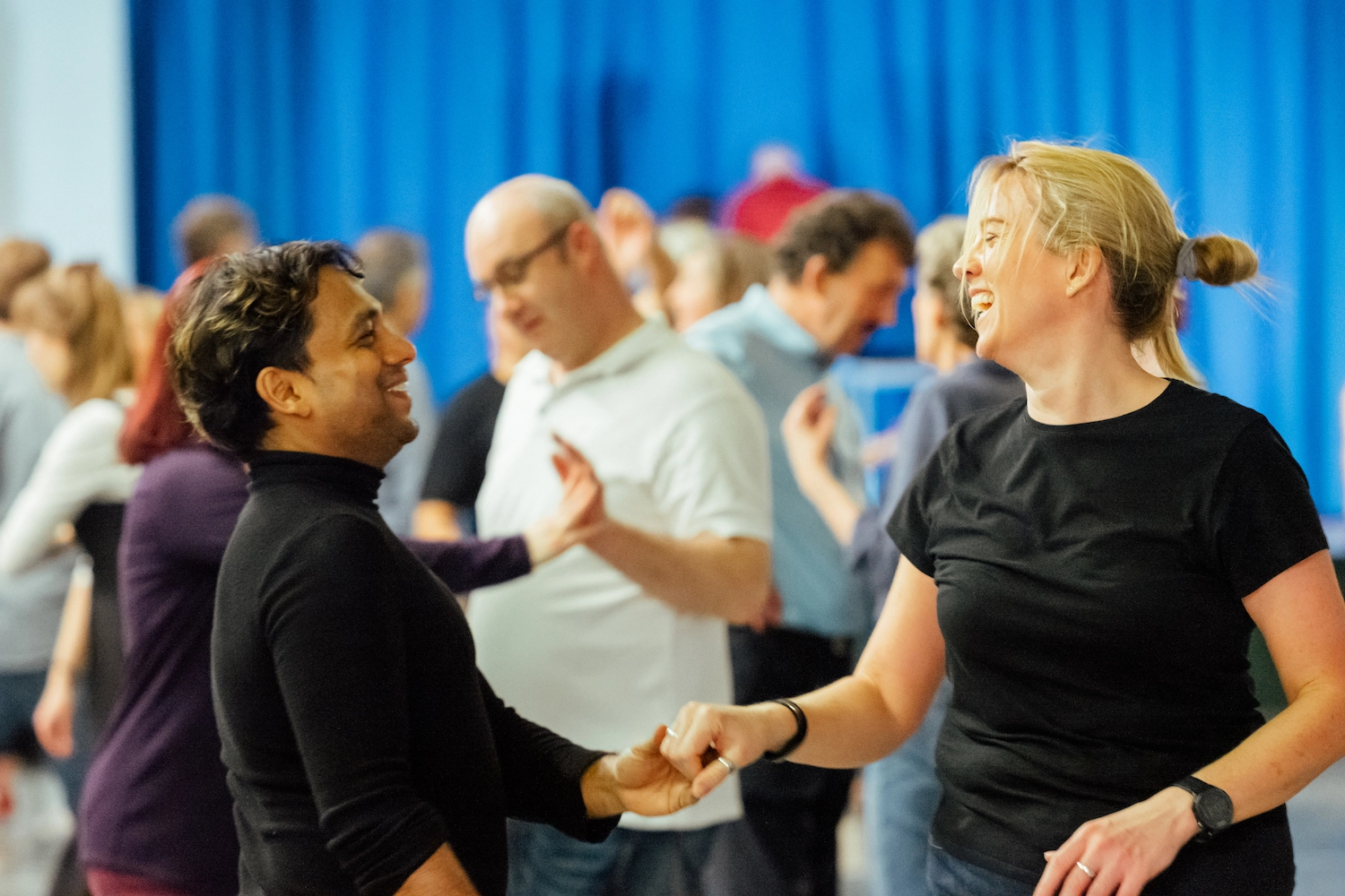 Couple dancing in a busy hall
